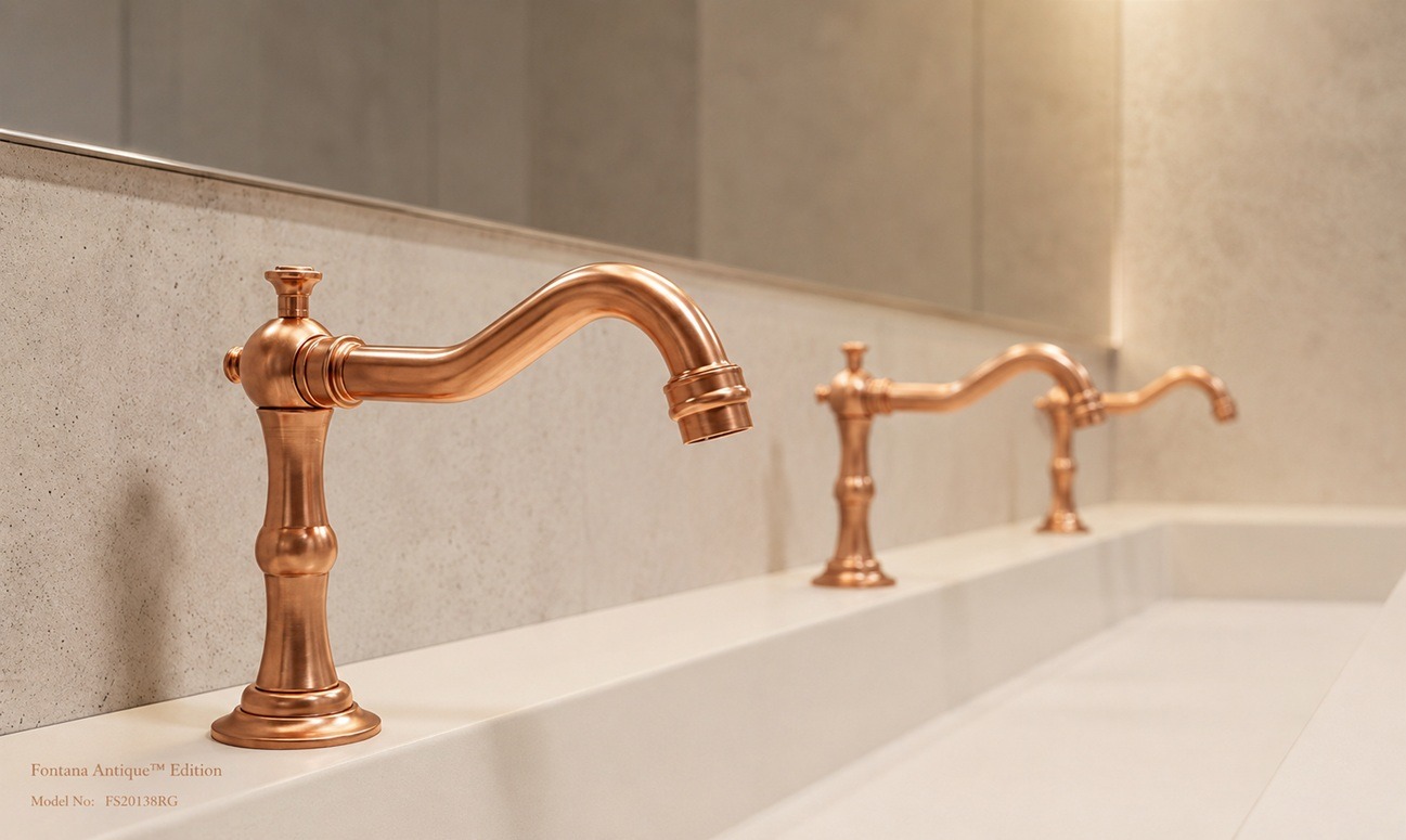 Fontana Antique Edition rose gold faucets installed along a white commercial trough sink in a warm, modern restroom interior.